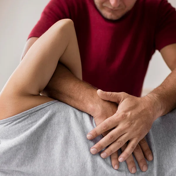 Un homme reçoit un massage d'une femme dans un cabinet d'ostéopathie à Montréal.